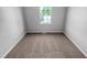Bright bedroom with a window and carpeted floor, freshly painted in neutral colors at 5600 Brandycrest Dr, Raleigh, NC 27610
