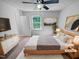 Comfortable bedroom featuring a ceiling fan, window with natural light, and neutral decor at 5600 Brandycrest Dr, Raleigh, NC 27610
