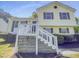 Charming two-story home with yellow siding, dark shutters, and a well-maintained landscaped yard at 5600 Brandycrest Dr, Raleigh, NC 27610