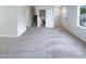 Living room featuring stairs, multiple doors, neutral carpet, and a window at 5600 Brandycrest Dr, Raleigh, NC 27610