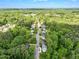 Expansive aerial view of the community featuring the home nestled among dense, mature trees at 621 Bon Air Ave, Durham, NC 27704