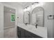 Modern bathroom features dual vanity, quartz countertops, modern lighting, and large walk-in shower at 621 Bon Air Ave, Durham, NC 27704