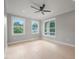 Bright bedroom with three large windows overlooking a lush green landscape and hardwood floors at 621 Bon Air Ave, Durham, NC 27704