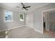 Bedroom with neutral walls, plush carpeting, large windows, ceiling fan, recessed lighting and closet at 621 Bon Air Ave, Durham, NC 27704