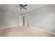Spacious bedroom with three doors, hardwood floors, modern ceiling fan, and recessed lighting at 621 Bon Air Ave, Durham, NC 27704