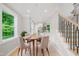 Cozy dining room with hardwood floors, a round table with four chairs, and bright natural light at 621 Bon Air Ave, Durham, NC 27704