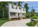 Two-story home with white siding, black trim, front porch, and manicured landscaping at 621 Bon Air Ave, Durham, NC 27704