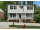 Two-story home featuring white siding, black trim, inviting front porch and well-maintained landscaping at 621 Bon Air Ave, Durham, NC 27704