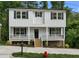 Front view of the charming two-story house with a porch, manicured landscaping, and a freshly painted exterior at 621 Bon Air Ave, Durham, NC 27704
