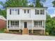 Charming two-story home with a covered porch, black shutters, and landscaped front yard at 621 Bon Air Ave, Durham, NC 27704