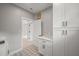 Laundry room with stylish tile floors, storage cabinets, and doorway leading to another room at 621 Bon Air Ave, Durham, NC 27704