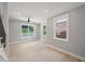 Light-filled living room with hardwood floors, multiple windows, and neutral wall color at 621 Bon Air Ave, Durham, NC 27704
