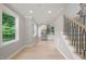 Open-concept area featuring hardwood floors, stainless refrigerator and stairs with black metal spindles at 621 Bon Air Ave, Durham, NC 27704