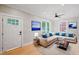 Comfortable living room featuring a large sectional sofa, hardwood floors, and bright natural light at 621 Bon Air Ave, Durham, NC 27704