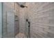 Tiled shower with glass enclosure, rainfall shower head, handheld sprayer, and built-in niche at 621 Bon Air Ave, Durham, NC 27704