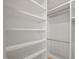 Bright walk-in closet with custom shelving and chrome hanging rods for optimal organization and storage solutions at 621 Bon Air Ave, Durham, NC 27704