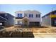 Two-story home featuring gray siding, brick accents, and an attached two-car garage awaiting landscaping at 631 White Birch Ln, Angier, NC 27501