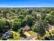Expansive aerial view showcasing a residential neighborhood with mature trees, providing a peaceful and private living environment at 704 N Orange Ave, Dunn, NC 28334