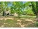 Expansive backyard featuring a wooden deck and lush landscaping for outdoor entertaining and relaxation at 704 N Orange Ave, Dunn, NC 28334