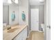 Clean bathroom featuring a well-lit mirror, a sink with storage, and a toilet, designed for functionality at 704 N Orange Ave, Dunn, NC 28334