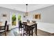 Cozy dining area with a modern table and chairs, complemented by a door to the backyard at 704 N Orange Ave, Dunn, NC 28334