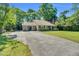 Charming single-story home featuring a lengthy driveway, lush lawn, and well-maintained landscaping around the perimeter at 704 N Orange Ave, Dunn, NC 28334