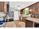 Bright kitchen with wood cabinetry, stainless steel appliances, a window, and tile flooring at 704 N Orange Ave, Dunn, NC 28334