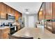 View of open-concept kitchen featuring stainless steel appliances, wooden cabinets, and an island counter with a bar stool at 704 N Orange Ave, Dunn, NC 28334