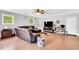 Spacious living room featuring modern furnishings, natural light, and a comfortable sectional for relaxing and entertaining at 704 N Orange Ave, Dunn, NC 28334