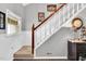 Elegant staircase with wood and white railings, leading to the upper level, and featuring stylish decor at 704 N Orange Ave, Dunn, NC 28334