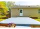 Backyard showing the house and patio, plus flowering potted plants at 705 Hartford Rd, Raleigh, NC 27610