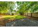 Spacious backyard with a gravel area and a well-maintained lawn at 705 Hartford Rd, Raleigh, NC 27610