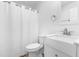 White bathroom features a sleek vanity, mirror, and shower-tub combination at 705 Hartford Rd, Raleigh, NC 27610