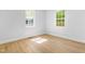 Corner bedroom bathed in natural light, showcasing neutral walls and modern flooring at 705 Hartford Rd, Raleigh, NC 27610