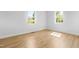 Bright bedroom with neutral walls and modern flooring, plus large windows at 705 Hartford Rd, Raleigh, NC 27610