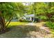 Charming single-story home with blue shutters, green lawn and mature shade trees at 705 Hartford Rd, Raleigh, NC 27610