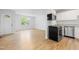 Open-concept living room and kitchen area with bright light and modern flooring at 705 Hartford Rd, Raleigh, NC 27610