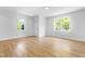 Bright and airy living room with hardwood flooring and large windows at 705 Hartford Rd, Raleigh, NC 27610
