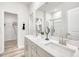 Bright bathroom with double sinks, granite counters, and a large mirror at 728 Deschutes Dr, Garner, NC 27529