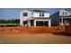 New construction home with a two-car garage and gray vinyl siding awaits its final touches at 728 Deschutes Dr, Garner, NC 27529
