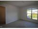 Well-lit bedroom with a window and neutral carpet, offering a bright and inviting space at 802 Brier Crossing Loop, Durham, NC 27703