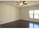 Bright bedroom with hardwood floors, ceiling fan, and natural light from a large window at 802 Brier Crossing Loop, Durham, NC 27703