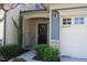Charming home entrance with stone accents, manicured bushes, and covered entryway at 802 Brier Crossing Loop, Durham, NC 27703
