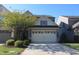 Two story home featuring an attached two car garage, manicured lawn, and mature shade tree at 802 Brier Crossing Loop, Durham, NC 27703