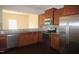 Well-equipped kitchen featuring stainless steel appliances, granite counters, and wood cabinetry at 802 Brier Crossing Loop, Durham, NC 27703