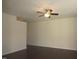 Spacious living room featuring dark hardwood floors, a ceiling fan, and natural light at 802 Brier Crossing Loop, Durham, NC 27703