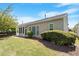 Well-maintained backyard featuring a screened porch, lawn, and manicured landscaping at 803 Footbridge Pl, Cary, NC 27519