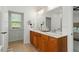Bright bathroom with double vanity and linen closet at 803 Footbridge Pl, Cary, NC 27519