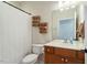 Bathroom with white shower curtain, stacked towels and vanity at 803 Footbridge Pl, Cary, NC 27519