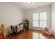Bedroom with hardwood floors, soft pink chair, and window at 803 Footbridge Pl, Cary, NC 27519